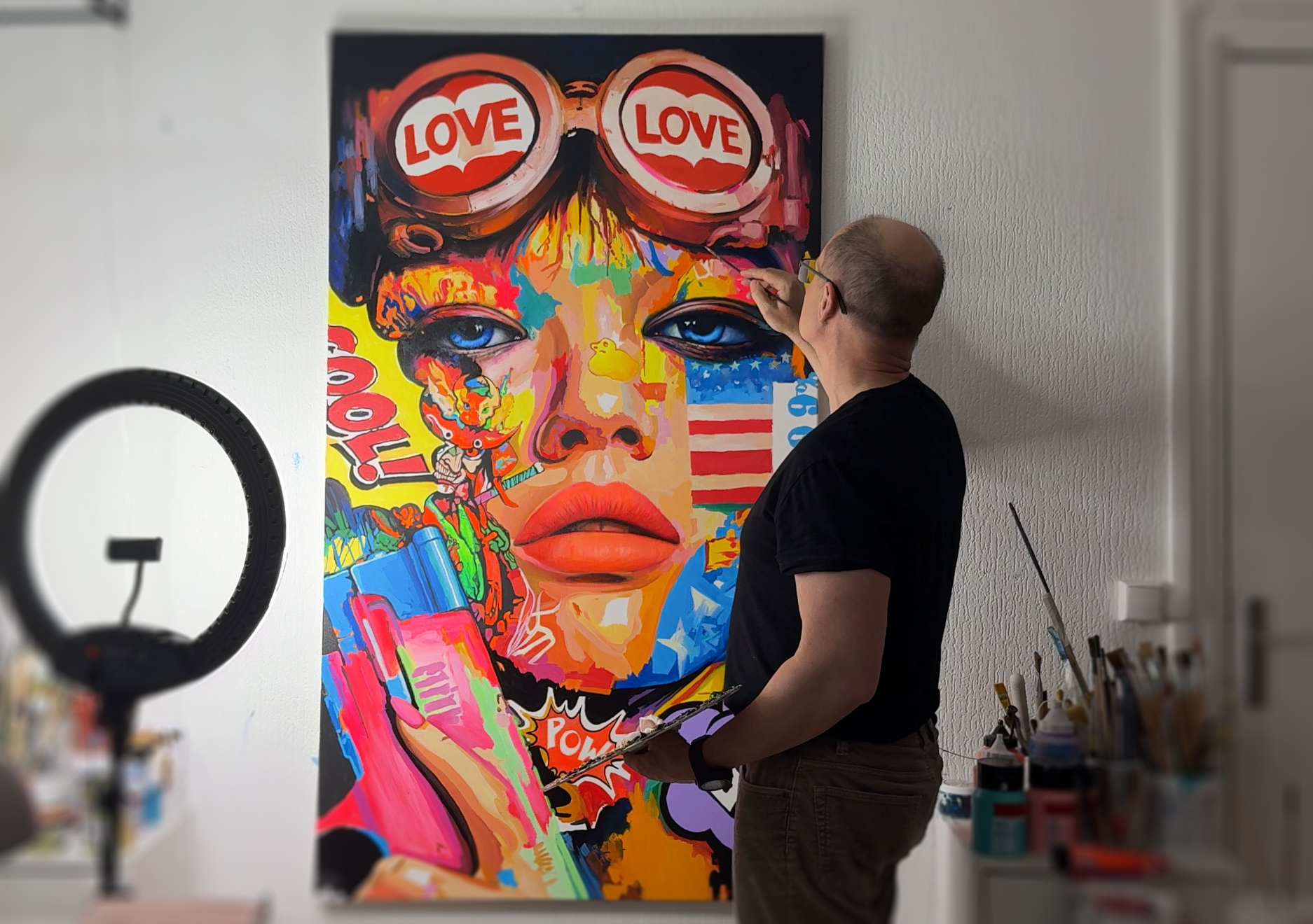 Contemporary artist Viacheslav Zaykin working on a large-scale pop art portrait in his Paris studio.
